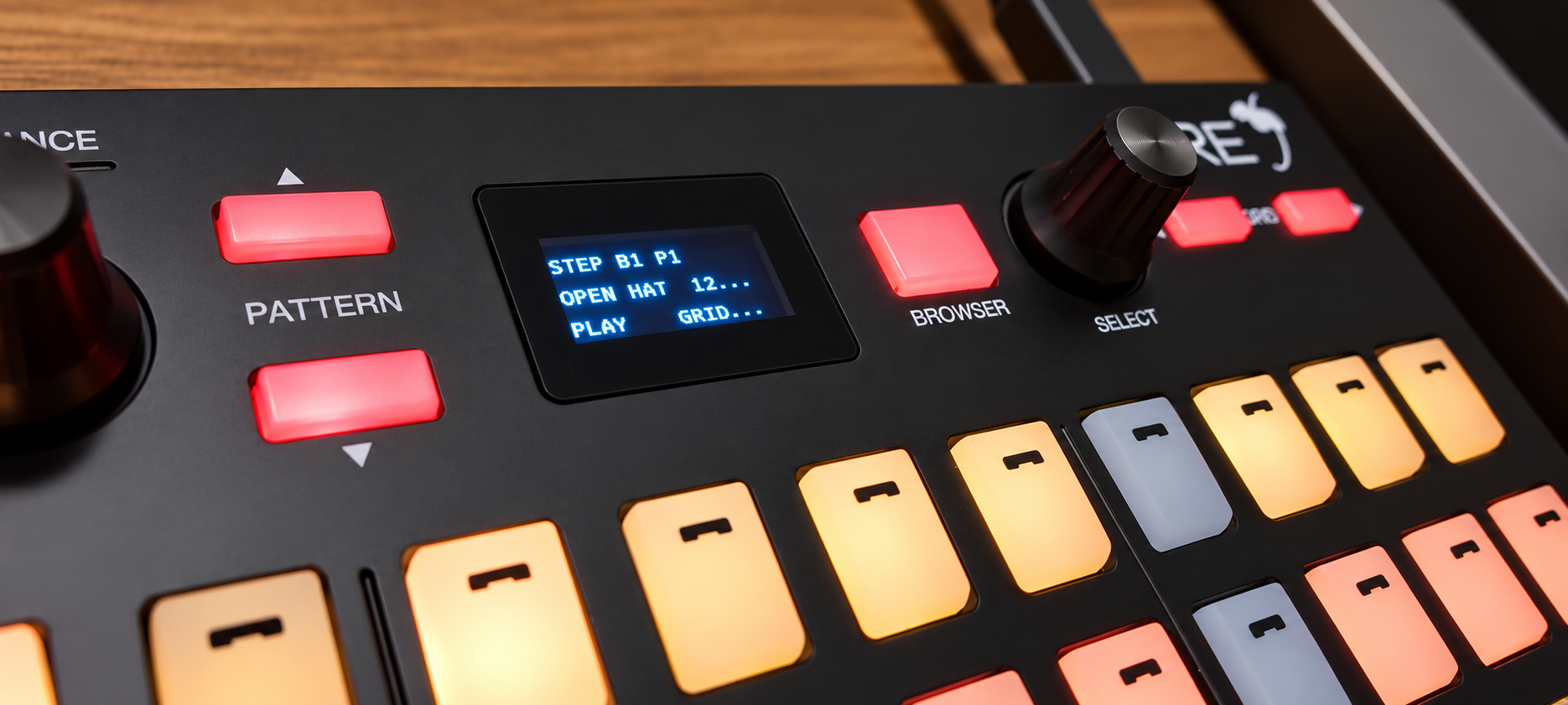 Close-up of the Fire controller with illuminated pads and a STEP playback display